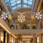 A banner featuring a series of snowflake shapes with warm white and cool white LED lights against a black background.